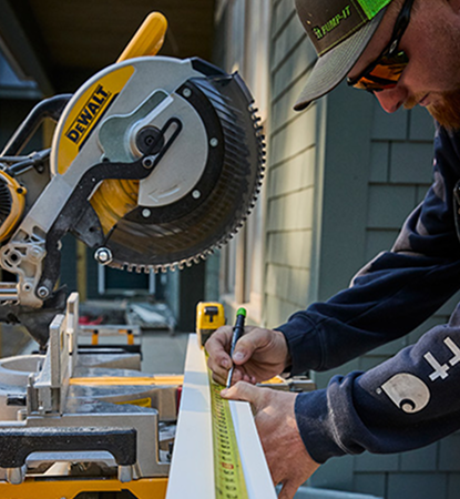 Worker measuring AZEK product to cut