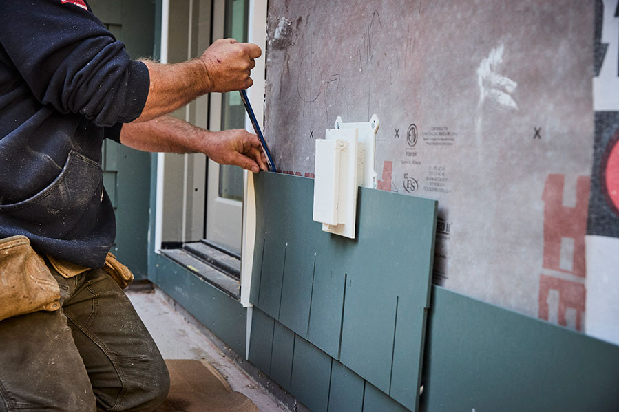 Worker Installing AZEK Material at ground level
